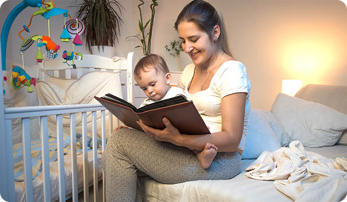 Mother reading young child bedtime story