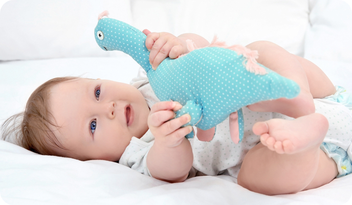 Baby playing toy dinosaur