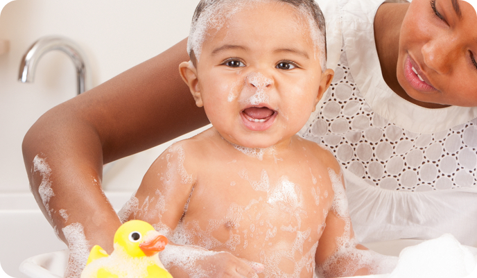 baby in bath with rubber duck